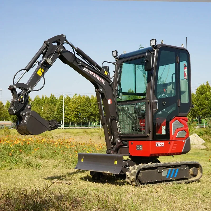 Rhinoceros XN22 mini excavator parked on grass with the boom extended